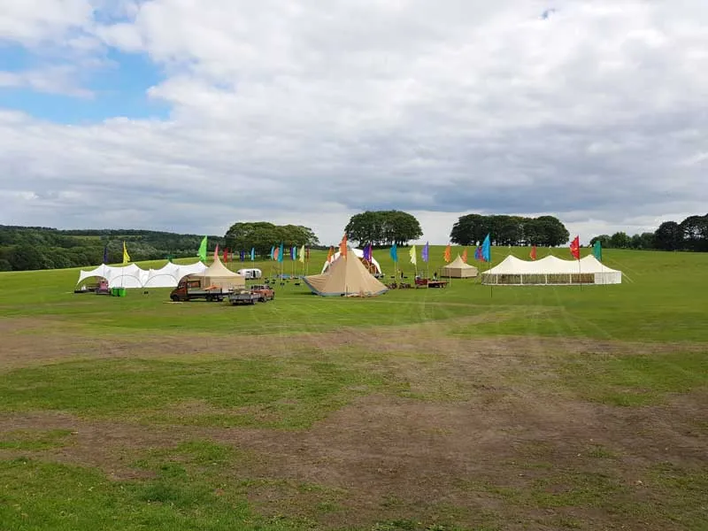 Marquees and flags set out across a field