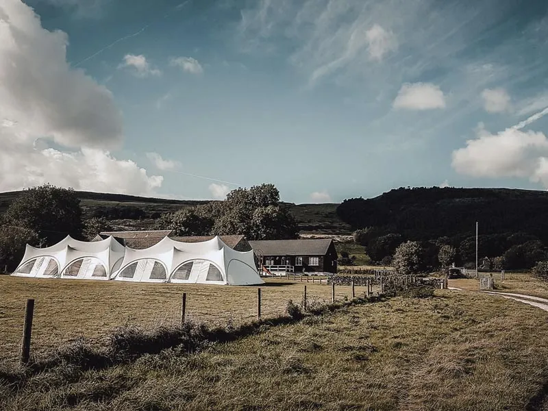 Double Trapeze marquee in a field at Castleton