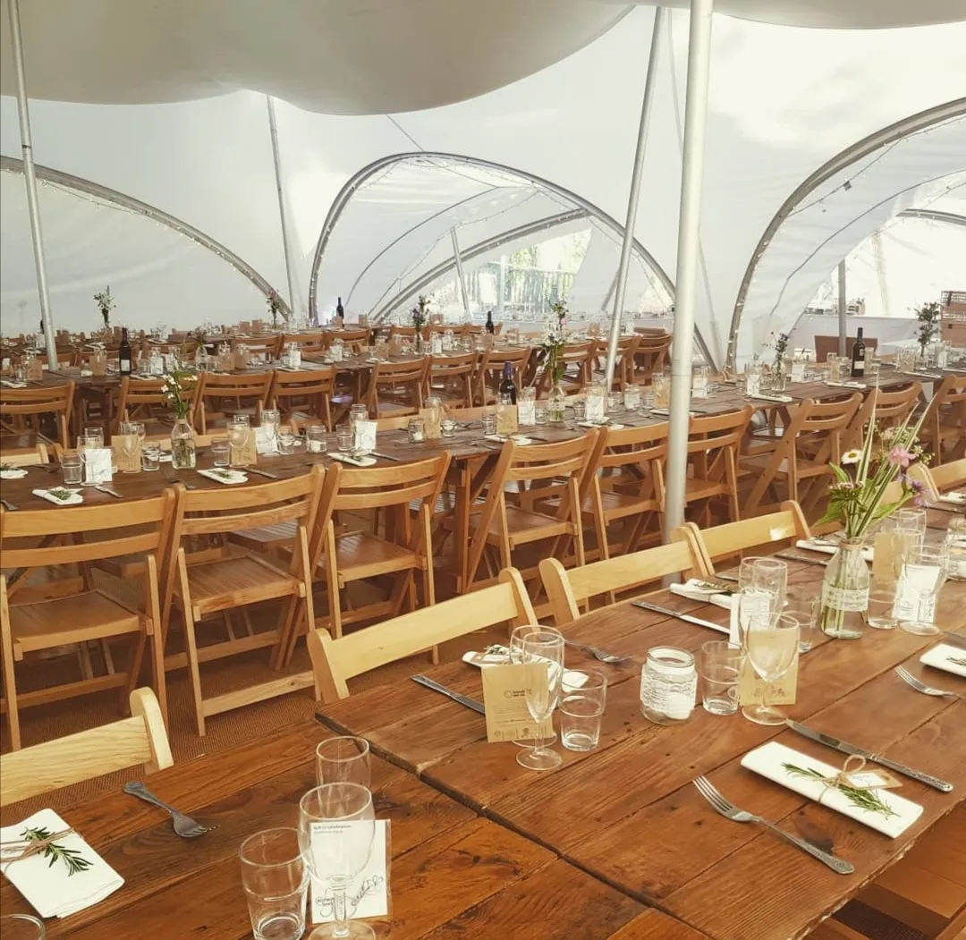 Dressed table and chairs inside a marquee