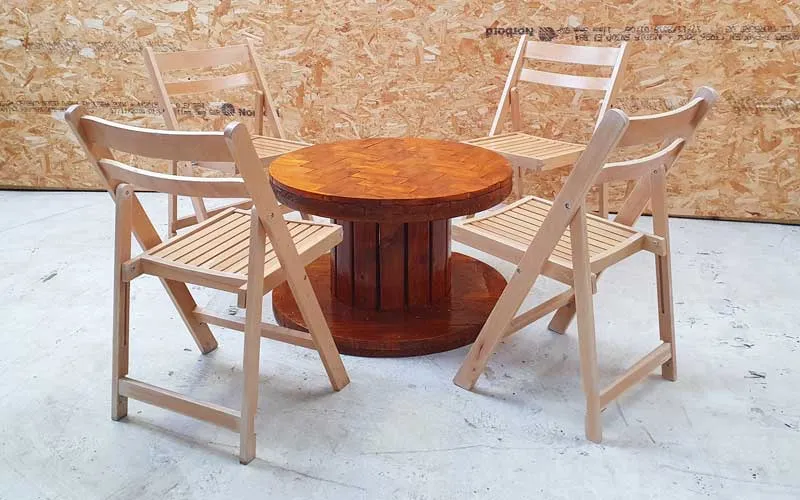 Low herringbone cable reel table with folding wooden chairs
