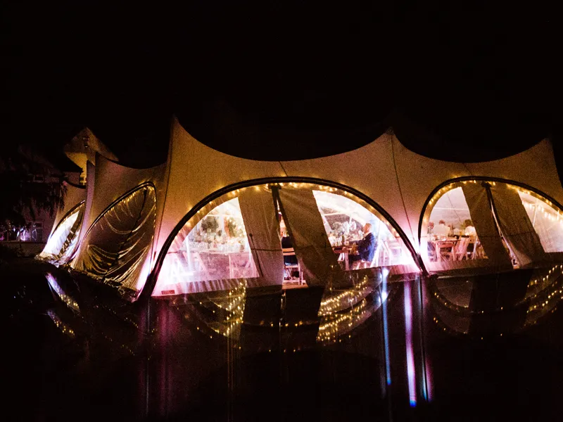 Trapeze marquee lit up after dark